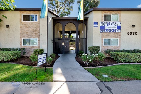 an apartment building with a walkway leading to the front door